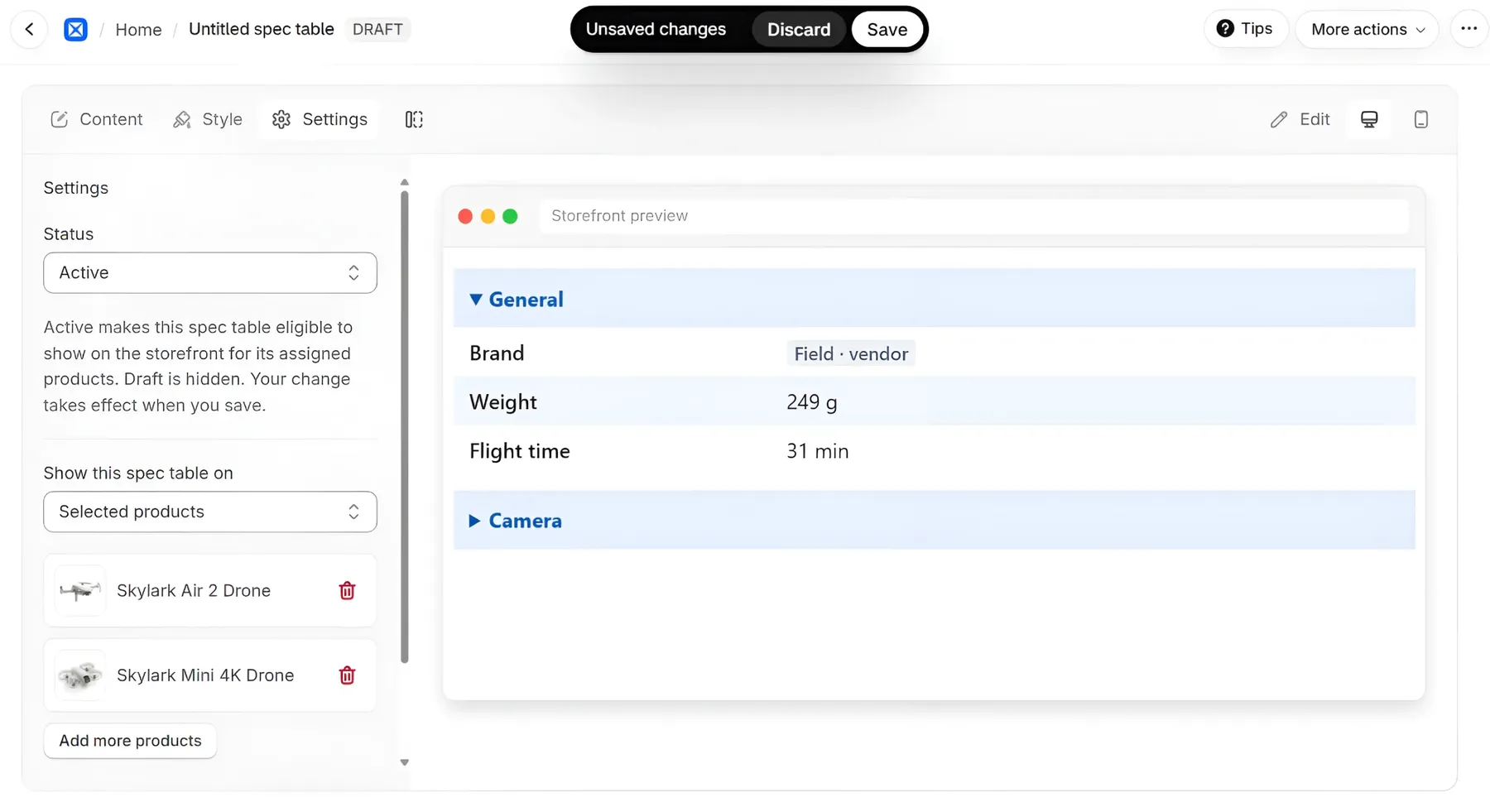 The Settings tab of an unsaved spec table: Status set to Active, "Show this spec table on" set to Selected products with two products listed and an Add more products button, and a storefront preview of the table on the right. The Unsaved changes bar with Discard and Save is at the top